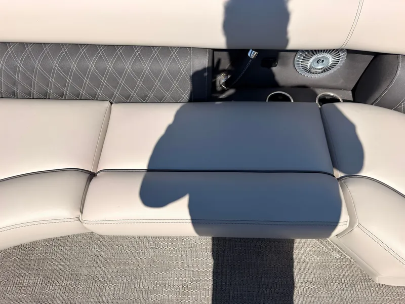 Slide: The Image of Light-colored upholstered seating on a boat with elegant stitching and a fan in the background. - 17