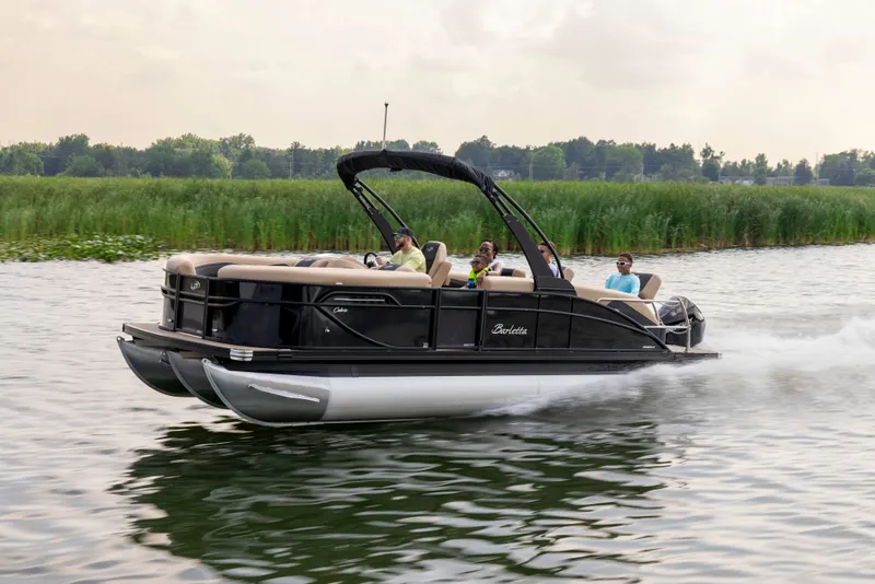 Slide: The Image of Barletta Cabrio 24 M 2026 pontoon boat on a lake. - 0