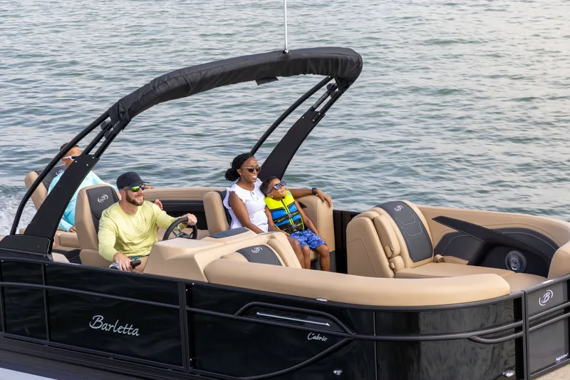 Slide: The Image of Family enjoying boat ride on Barletta Cabrio 24 M, 2026 model. - 1