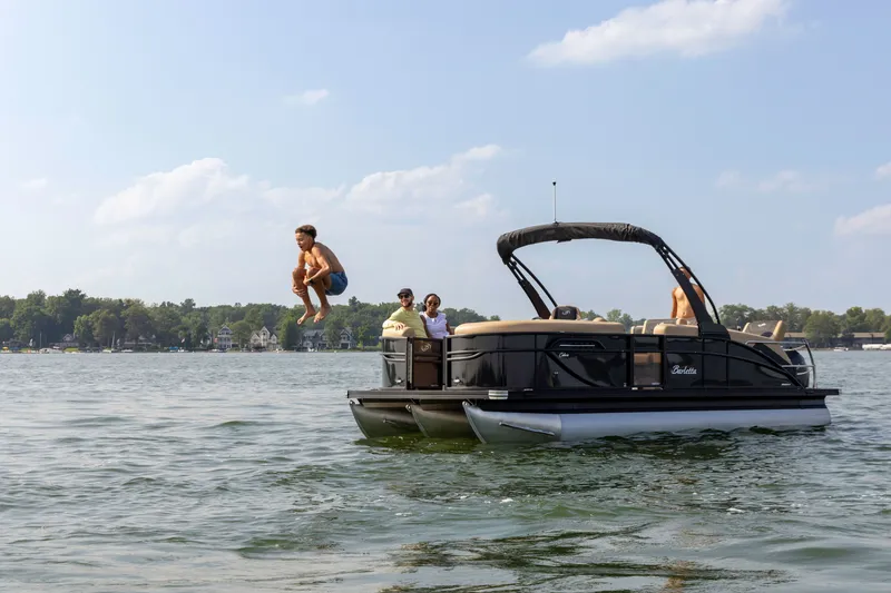 Slide: The Image of Person jumping off Barletta Cabrio 24 M pontoon boat, 2026 model. - 6