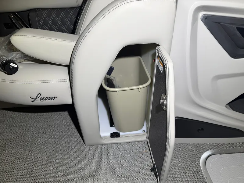Slide: The Image of An open storage compartment in a Barletta Lusso 23 QCSS boat reveals a trash bin. - 16
