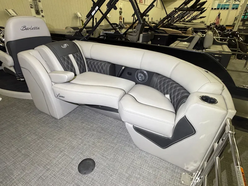 Slide: The Image of The image shows a luxurious, upholstered seating area in a Barletta Lusso 23 QCSS boat. - 33