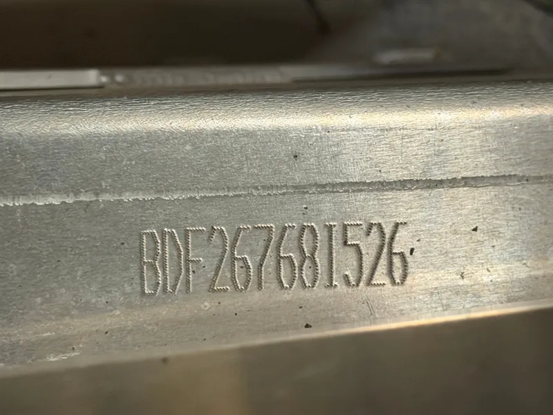 Slide: The Image of Close-up of a metal surface with an engraved serial number: BDF267681526. - 42