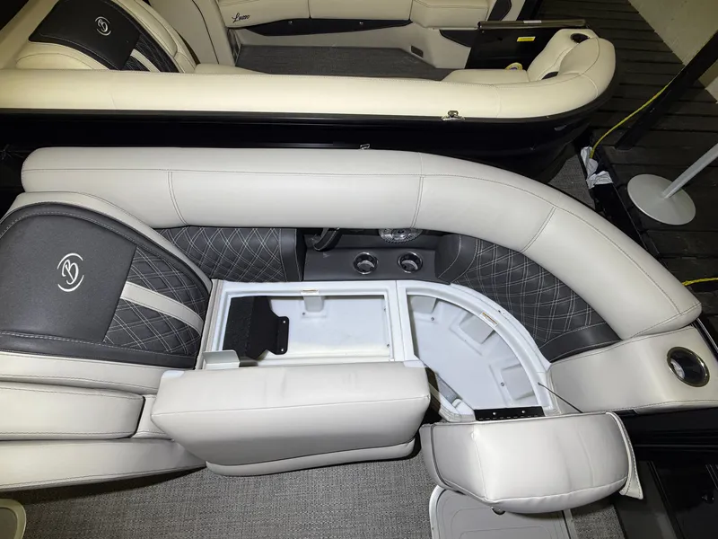 Slide: The Image of Interior of a Barletta Lusso 23 QCSS with elegant upholstered seating and a built-in cooler. - 13