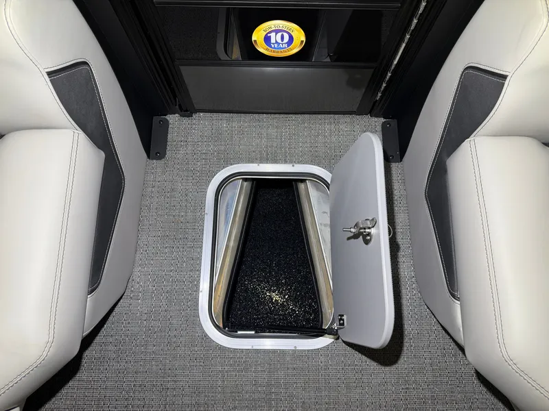 Slide: The Image of An open floor storage compartment with carpeted flooring and two white seats beside it. - 17