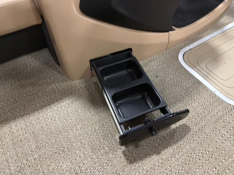 Slide: The Image of Barletta Cabrio 22 U 2026, pull-out cup holder on carpeted floor. - 7