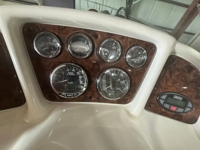 Slide: The Image of Dashboard of 2004 Sea Ray 260 Sundancer with gauges and Clarion audio system. - 12