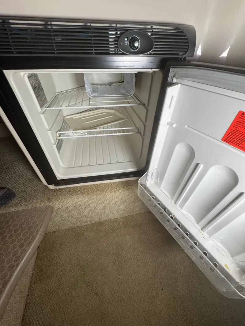 Slide: The Image of Open refrigerator inside a 2004 Sea Ray 260 Sundancer boat cabin. - 19