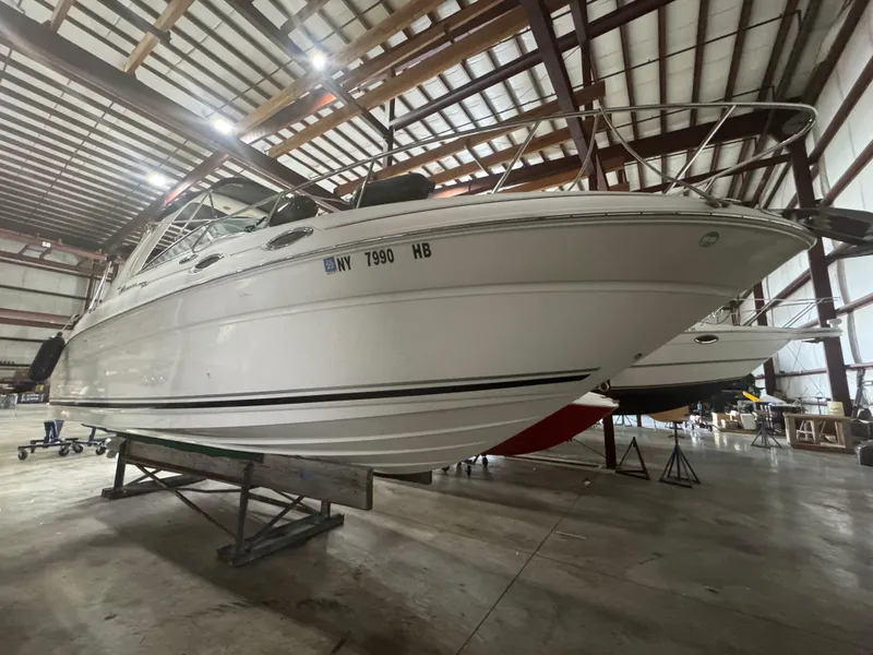 Slide: The Image of 2004 Sea Ray 260 Sundancer boat in indoor storage facility. - 2