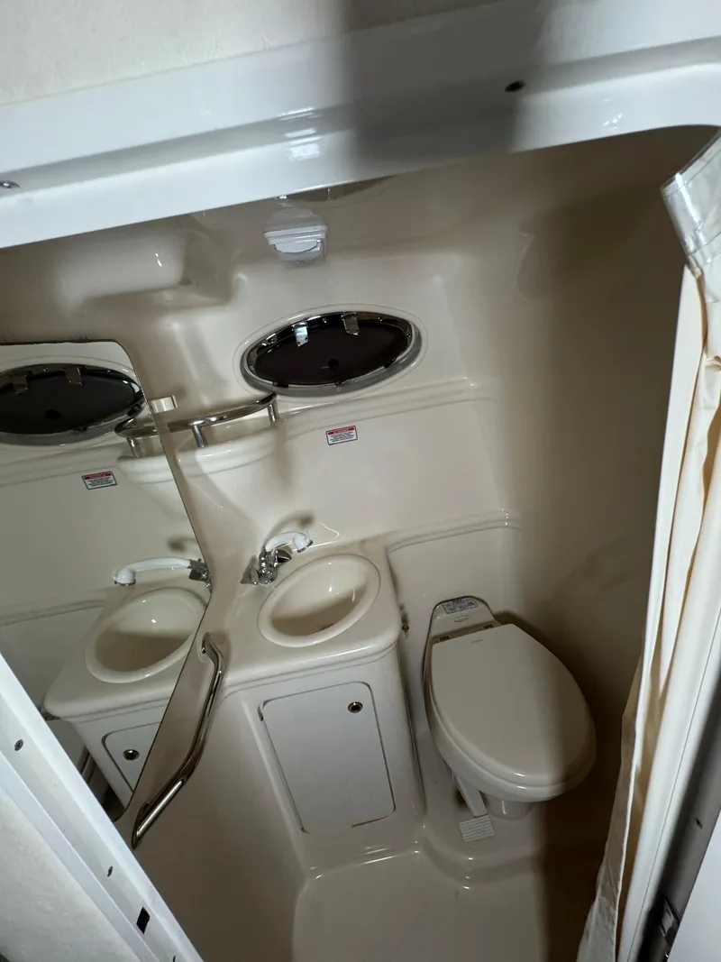 Slide: The Image of Compact bathroom in 2004 Sea Ray 260 Sundancer boat with sink and toilet. - 21