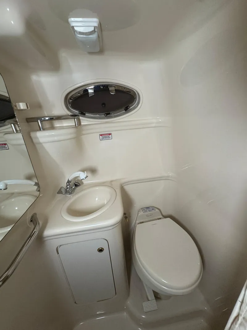 Slide: The Image of Compact bathroom in 2004 Sea Ray 260 Sundancer boat with sink and toilet. - 22