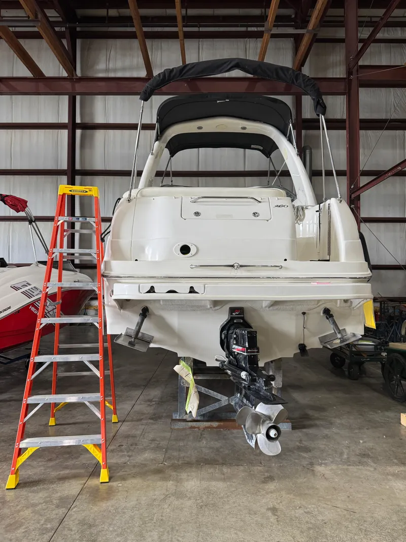 Slide: The Image of 2004 Sea Ray 260 Sundancer in storage with ladder beside it. - 3