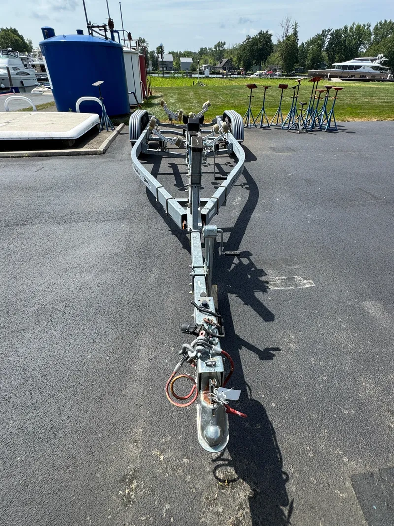 Slide: The Image of Boat trailer for 2004 Sea Ray 260 Sundancer on asphalt, surrounded by equipment. - 30