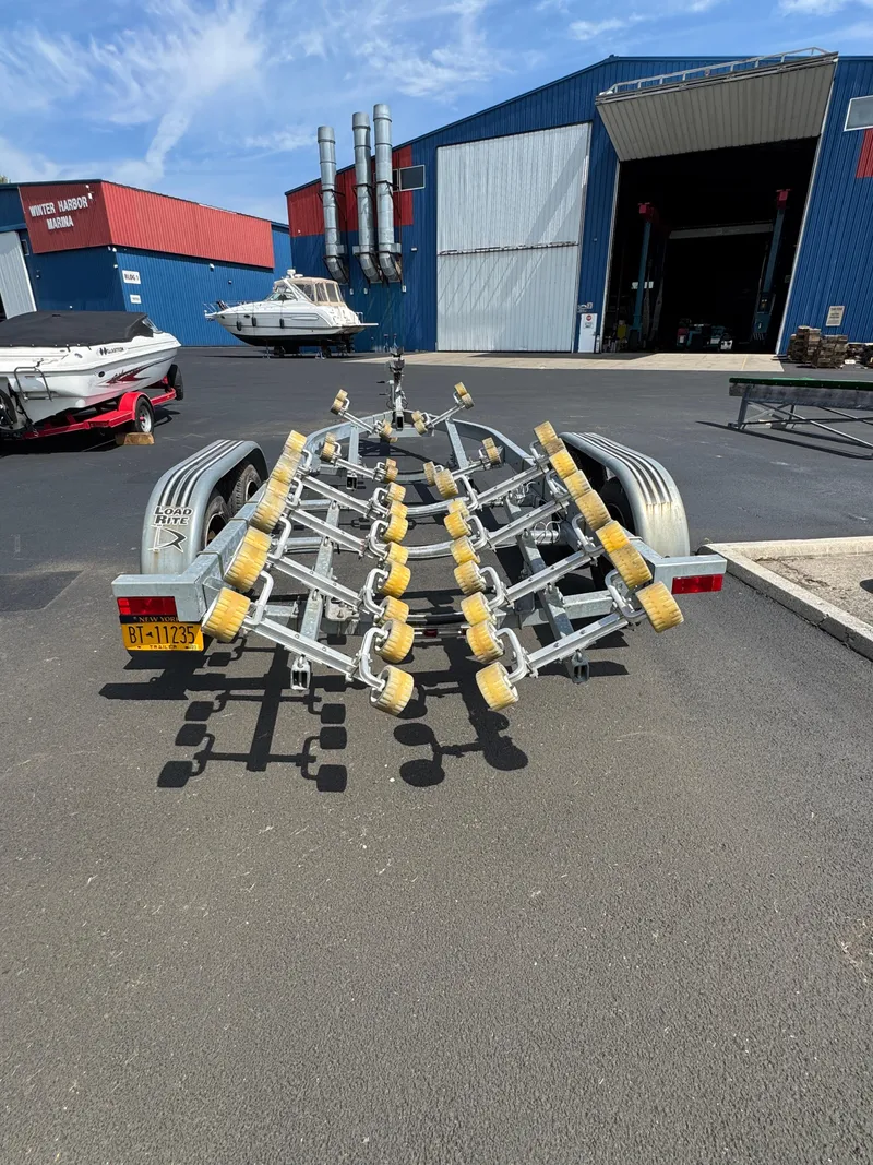 Slide: The Image of Boat trailer at marina, Sea Ray 260 Sundancer, 2004 model, parked outside large blue building. - 34