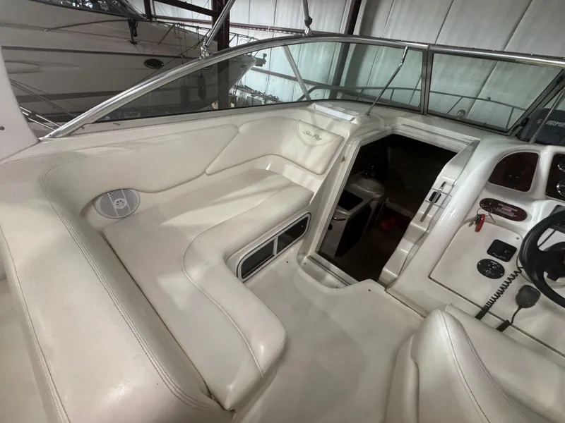 Slide: The Image of Interior of 2004 Sea Ray 260 Sundancer boat with white seating and control panel. - 5