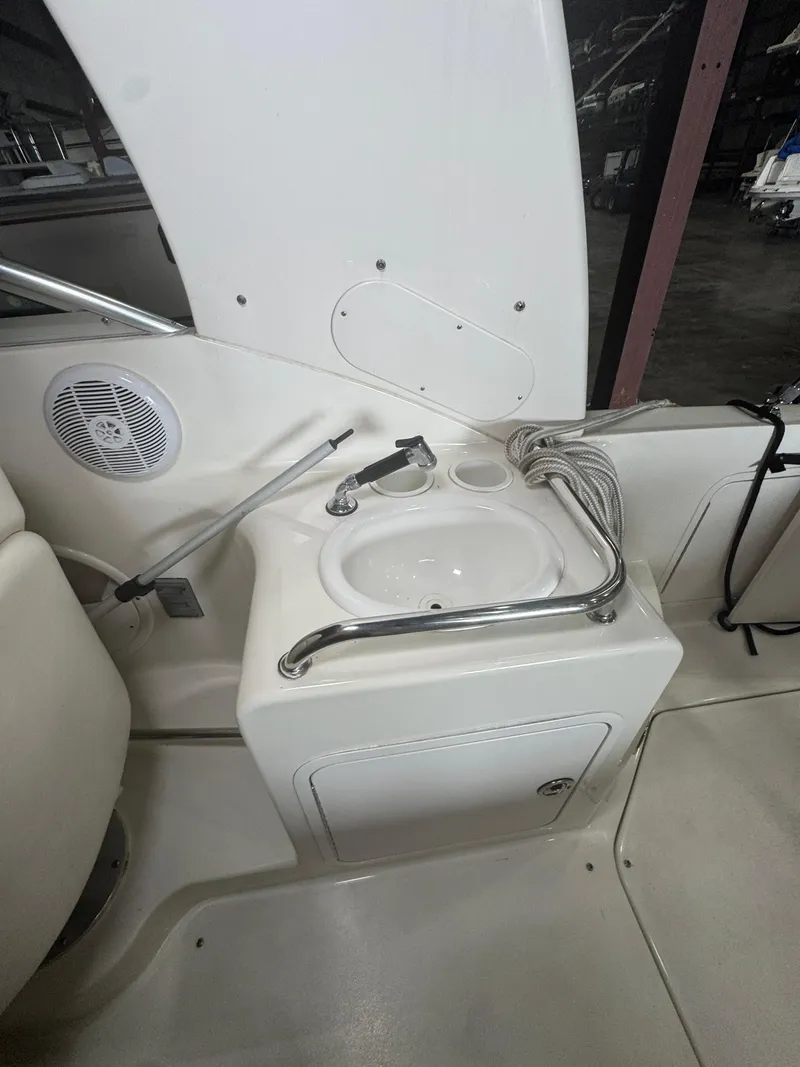 Slide: The Image of 2004 Sea Ray 260 Sundancer boat sink area with faucet and speaker. - 6