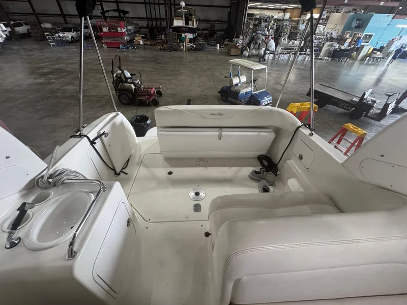 Slide: The Image of 2004 Sea Ray 260 Sundancer boat interior in a warehouse setting. - 8