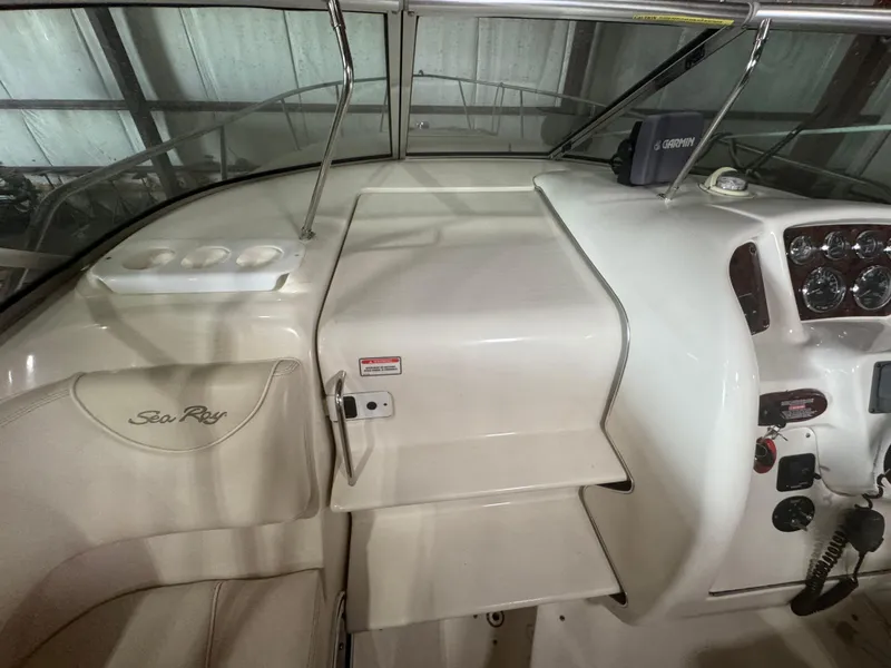 Slide: The Image of 2004 Sea Ray 260 Sundancer cockpit with steering controls and Garmin navigation system. - 9