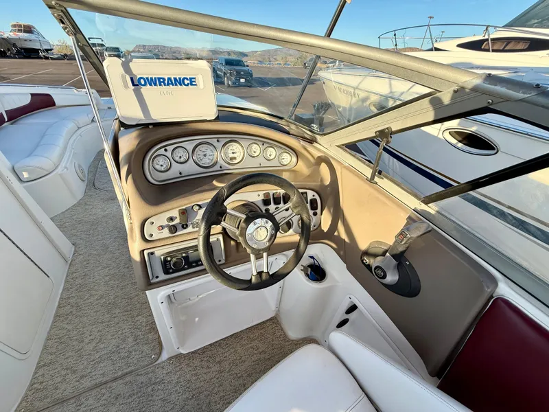 Slide: The Image of 2013 Ebbtide 2500 SS Fun Cruiser DC dashboard with steering wheel and Lowrance navigation system. - 11
