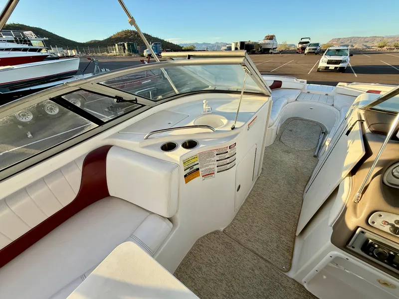 Slide: The Image of 2013 Ebbtide 2500 SS Fun Cruiser DC interior with white seating and dashboard view. - 12