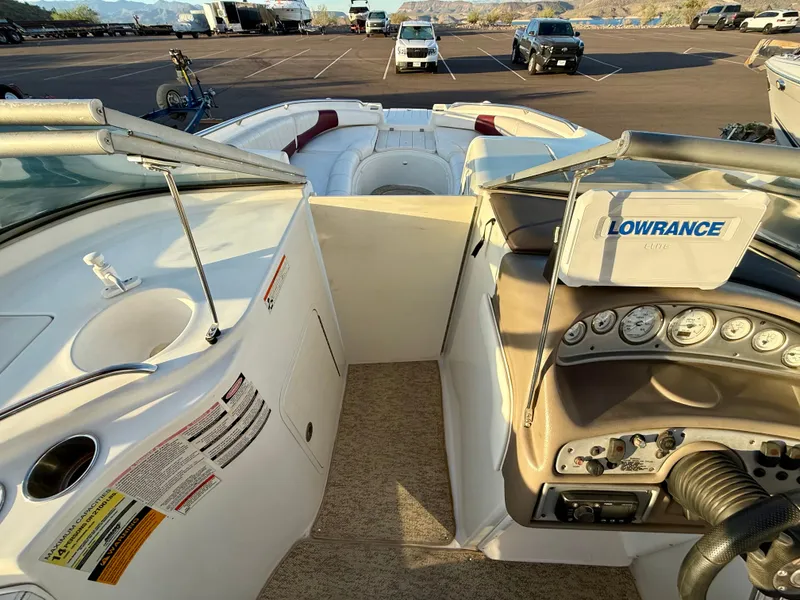Slide: The Image of 2013 Ebbtide 2500 SS Fun Cruiser DC boat interior with dashboard and seating area. - 13