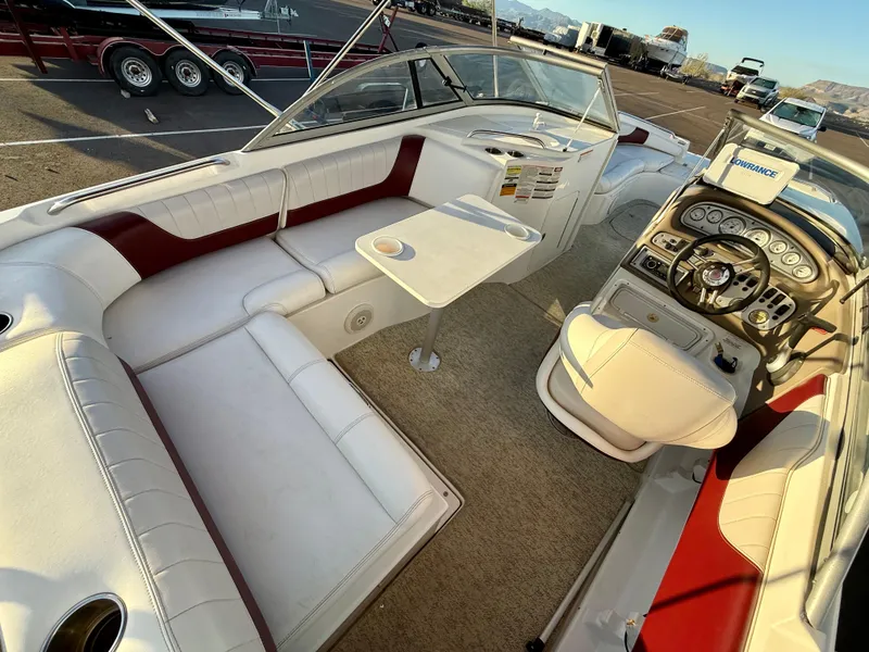 Slide: The Image of 2013 Ebbtide 2500 SS Fun Cruiser DC interior with white seating and helm. - 15