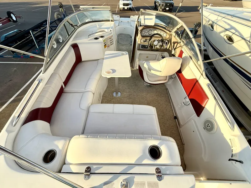 Slide: The Image of 2013 Ebbtide 2500 SS Fun Cruiser DC boat interior with seating and steering console. - 4