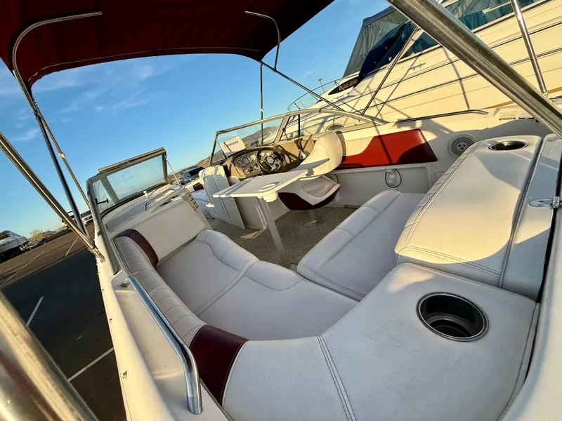 Slide: The Image of 2013 Ebbtide 2500 SS Fun Cruiser DC interior with white seating and red accents. - 6