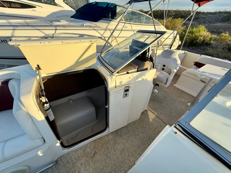 Slide: The Image of 2013 Ebbtide 2500 SS Fun Cruiser DC interior with seating and storage compartments. - 9