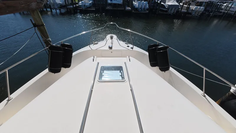 Slide: The Image of 2001 Sea Ray 450 Express Bridge yacht bow view at marina. - 12