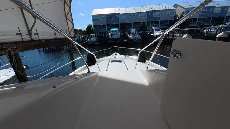 Slide: The Image of 2001 Sea Ray 450 Express Bridge yacht docked at marina, view from deck. - 14