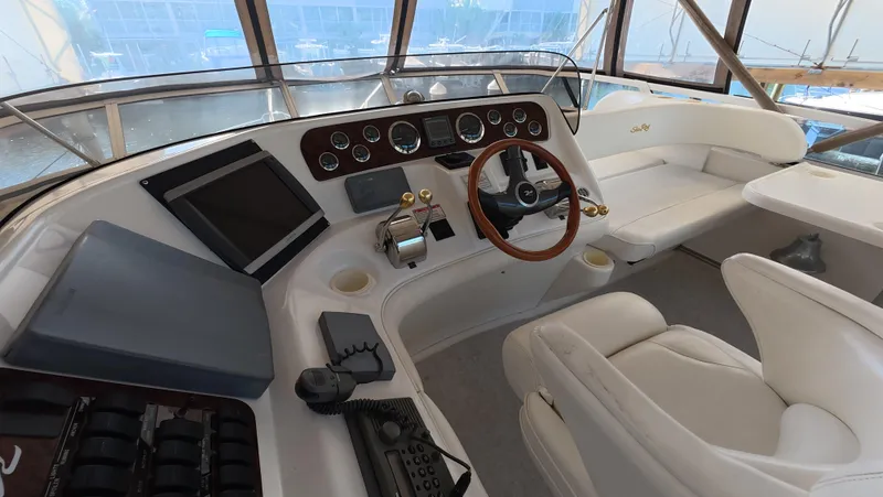 Slide: The Image of 2001 Sea Ray 450 Express Bridge helm with modern controls and luxurious seating. - 17