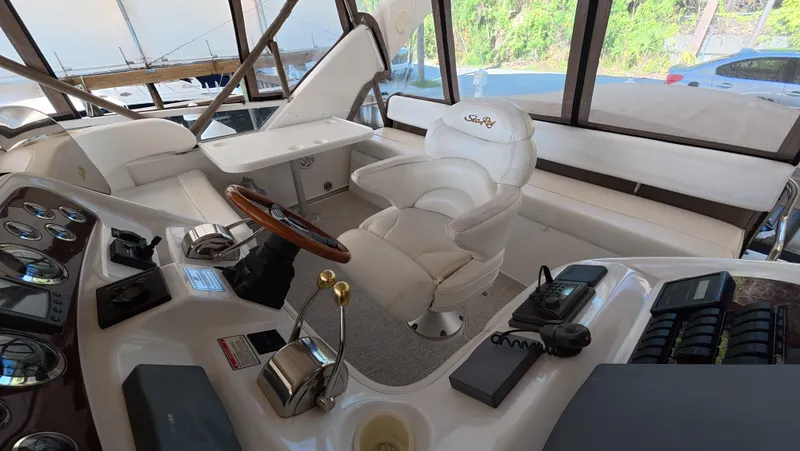 Slide: The Image of 2001 Sea Ray 450 Express Bridge helm with luxurious seating and control panel. - 20