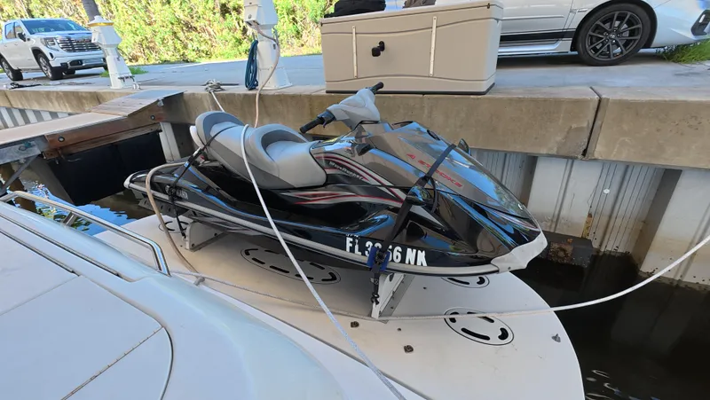 Slide: The Image of Jet ski secured on a 2001 Sea Ray 450 Express Bridge at a dock. - 26