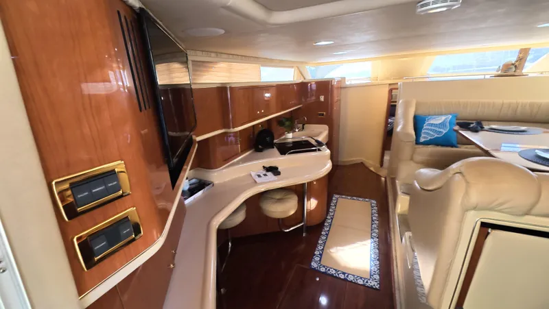 Slide: The Image of Luxurious interior of 2001 Sea Ray 450 Express Bridge yacht with elegant wood finishes. - 28