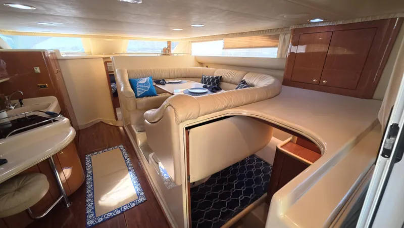 Slide: The Image of Luxurious interior of 2001 Sea Ray 450 Express Bridge yacht with elegant seating and cabinetry. - 29