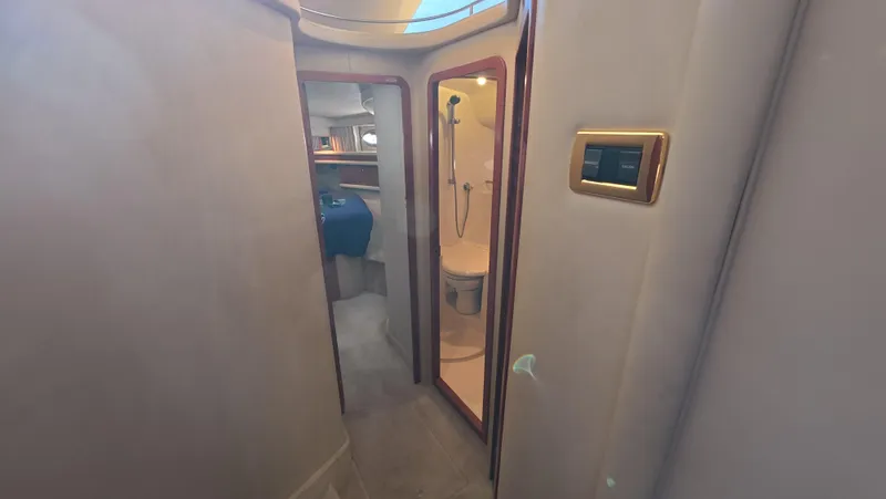 Slide: The Image of Interior of 2001 Sea Ray 450 Express Bridge, featuring bathroom and cabin area. - 33