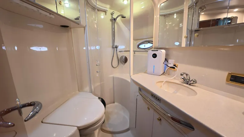 Slide: The Image of Luxurious bathroom in 2001 Sea Ray 450 Express Bridge yacht, featuring shower and vanity. - 35