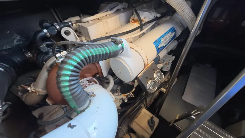 Slide: The Image of Engine compartment of a 2001 Sea Ray 450 Express Bridge, showcasing mechanical components and gauges. - 44