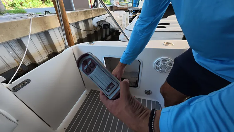 Slide: The Image of Man operating controls on a 2001 Sea Ray 450 Express Bridge boat. - 45