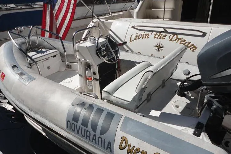Slide: The Image of 2001 Sea Ray 450 Express Bridge with Novurania tender, featuring "Livin' the Dream" text. - 52