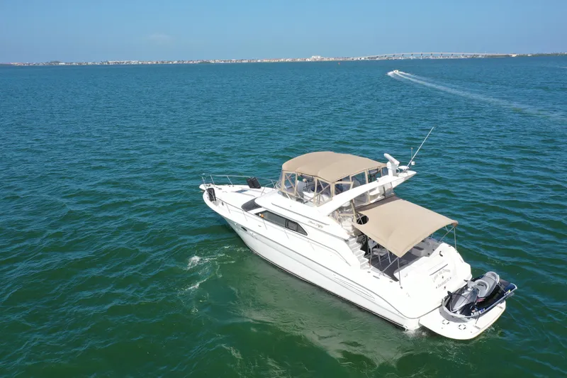 Slide: The Image of 2001 Sea Ray 450 Express Bridge yacht cruising on open water. - 8