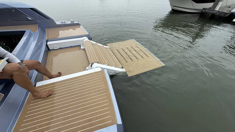 Slide: The Image of Luxury yacht Santasevera52 with extended swim platform, 2026 model, docked on calm water. - 19