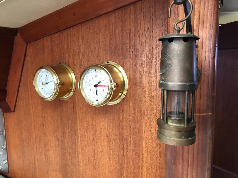 Slide: The Image of Brass gauges and lantern on 1988 Ericson 30+ wooden interior. - 14