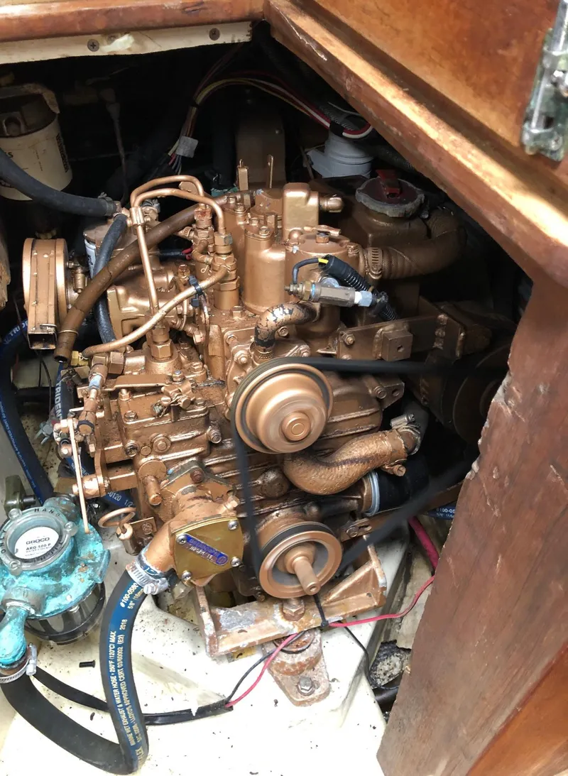 Slide: The Image of Engine compartment of a 1988 Ericson 30+ sailboat, showcasing mechanical components and wiring. - 19