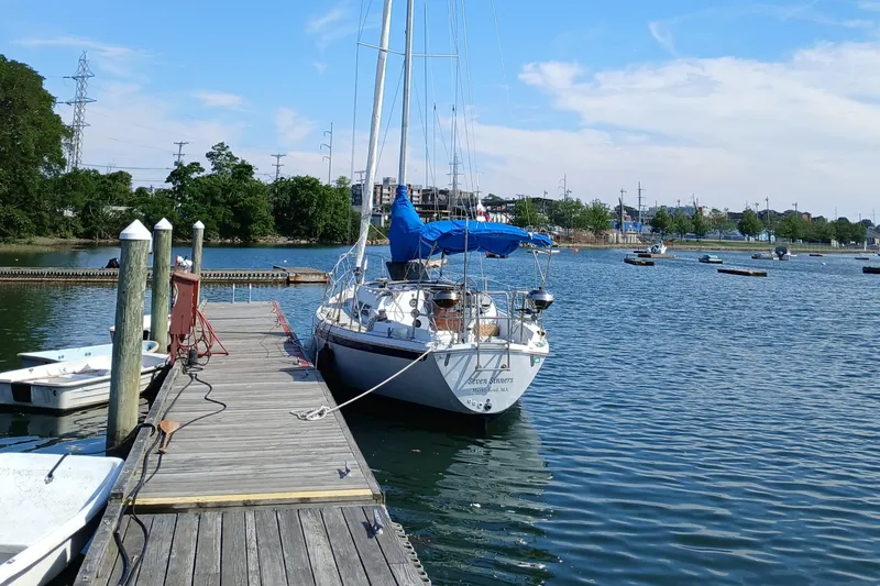 Slide: The Image of Sailboat Ericson 30+ (1988) docked at a marina on a sunny day. - 2
