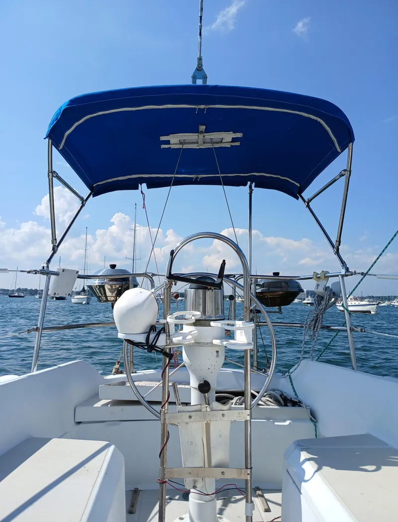 Slide: The Image of Cockpit view of 1988 Ericson 30+ sailboat with blue canopy on a sunny day. - 3