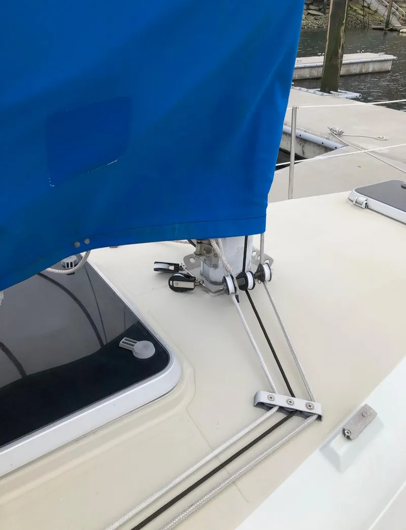 Slide: The Image of 1988 Ericson 30+ sailboat deck with blue sail cover and rigging details. - 8