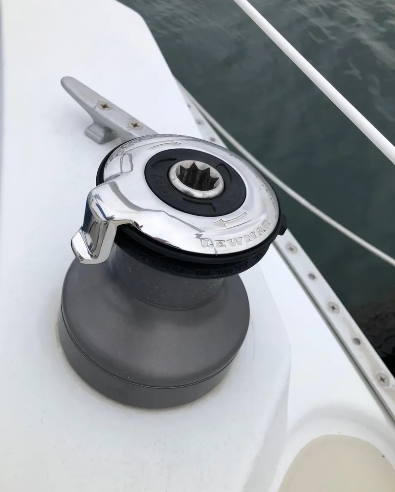 Slide: The Image of Sailboat winch on 1988 Ericson 30+ deck, near water. - 9