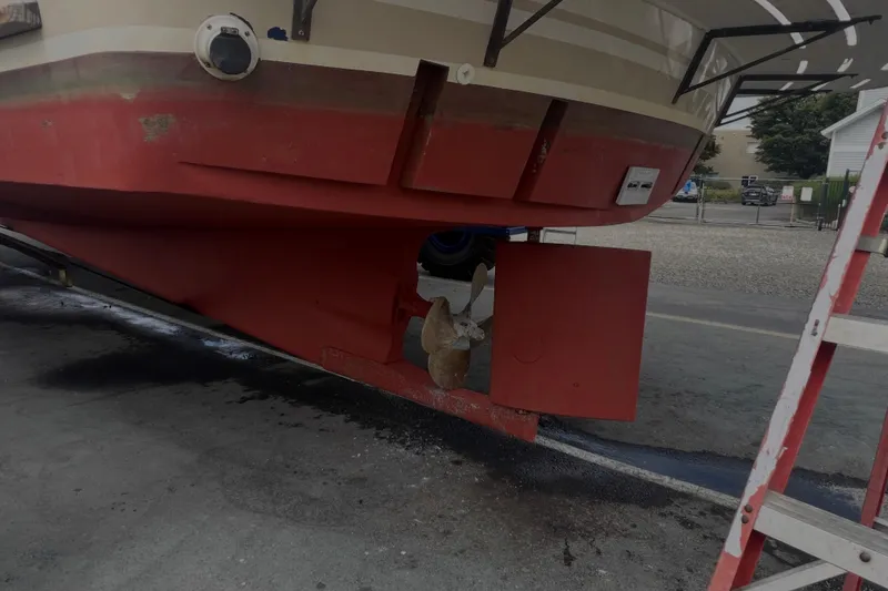 Slide: The Image of 1998 Cherubini Independence boat hull with visible propeller and rudder in a dry dock. - 104